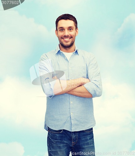 Image of smiling man with crossed arms