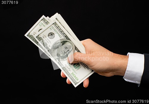 Image of close up of male hands holding dollar cash money