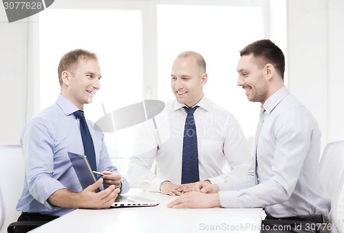 Image of business team working with laptop in office