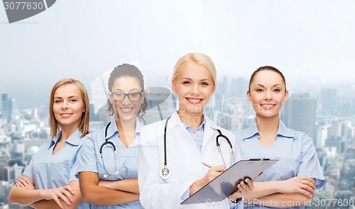 Image of smiling female doctor and nurses with stethoscope