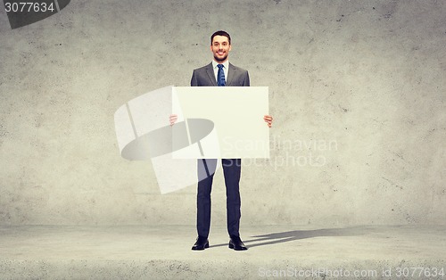 Image of smiling businessman with white blank board