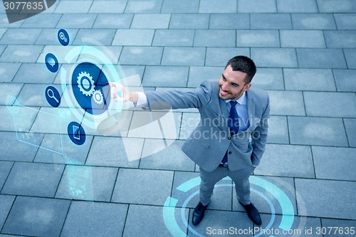 Image of young smiling businessman outdoors from top