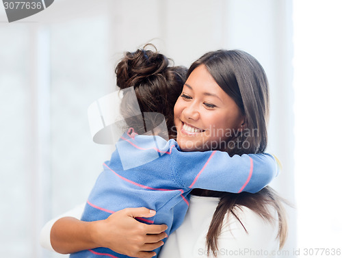 Image of hugging mother and daughter