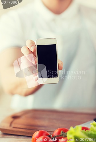 Image of close up of male hands holding smartphone