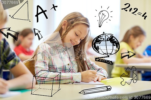 Image of group of school kids writing test in classroom