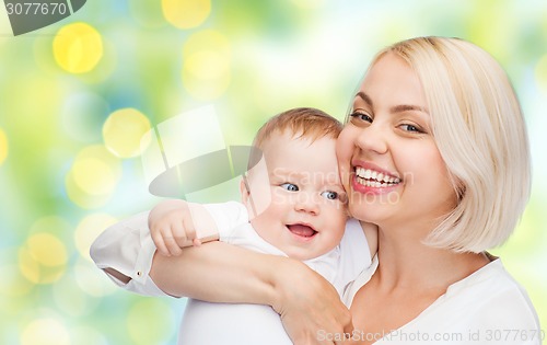 Image of happy mother with baby over green background