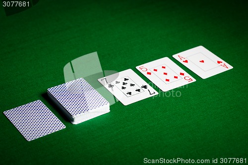 Image of playing cards on green table surface