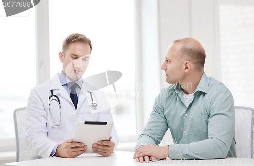 Image of doctor with tablet pc and patient in hospital