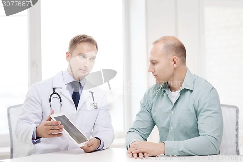 Image of doctor with tablet pc and patient in hospital