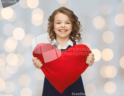 Image of smiling little girl with red heart