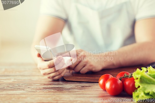 Image of closeup of man pointing finger to smartphone