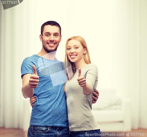 Image of smiling couple showing thumbs up