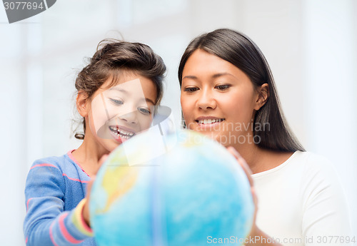 Image of mother and daughter with globe