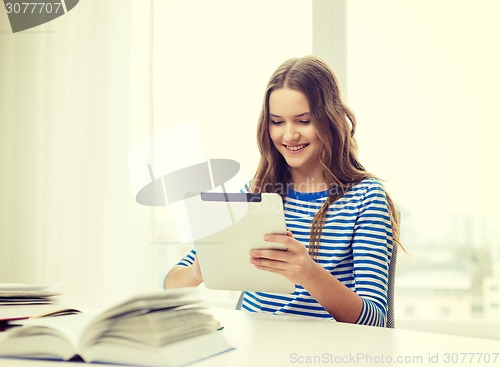 Image of smiling student girl with tablet pc and books