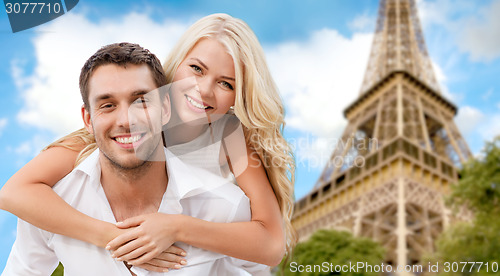 Image of happy couple having fun over eiffel tower