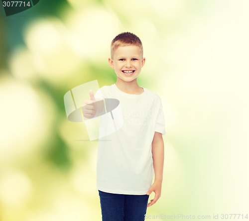 Image of smiling boy in white t-shirt showing thumbs up