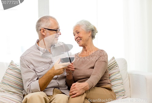 Image of happy senior couple with glasses of red wine