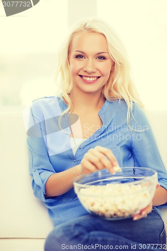 Image of young girl with popcorn ready to watch movie