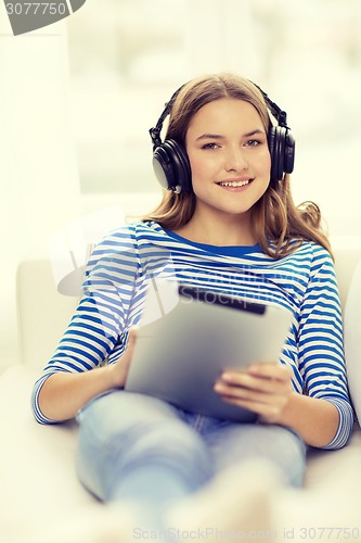 Image of girl with tablet pc and headphones at home