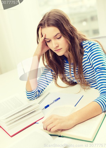 Image of stressed student girl with books