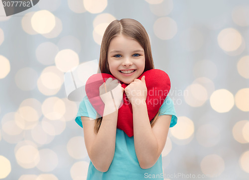 Image of smiling little girl with red heart
