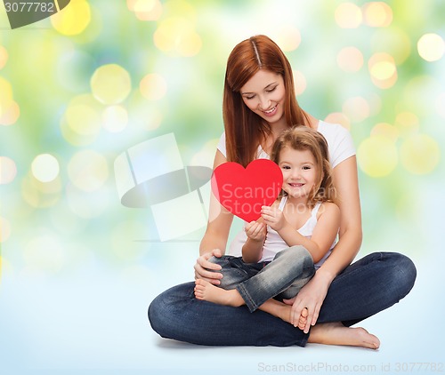 Image of happy mother with little girl holding red heart