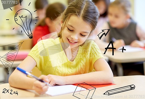 Image of group of school kids writing test in classroom