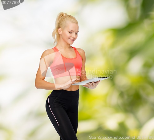 Image of smiling sporty woman with tablet pc computer