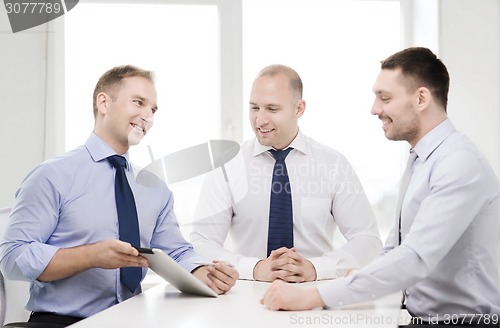 Image of business team working with tablet pc in office
