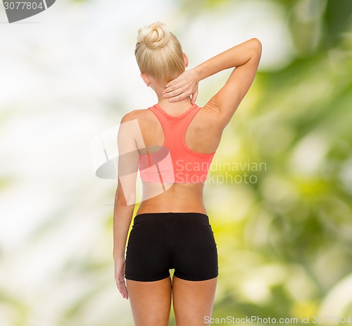 Image of sporty woman touching her neck