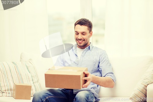 Image of man with cardboard boxes at home