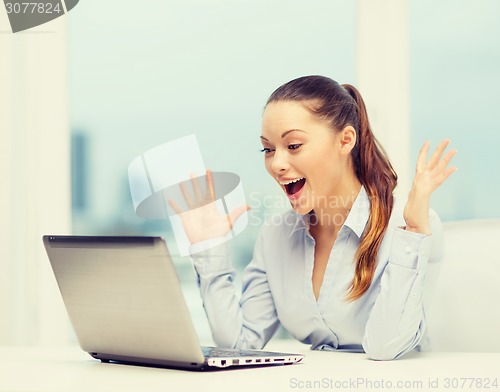 Image of surprised businesswoman with laptop