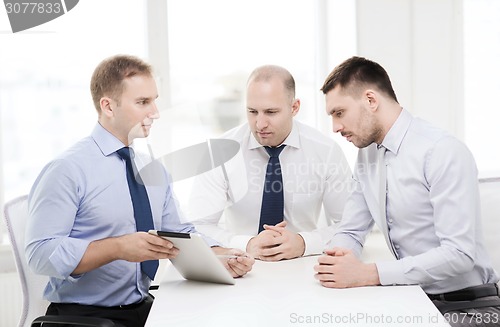 Image of business team working with tablet pc in office