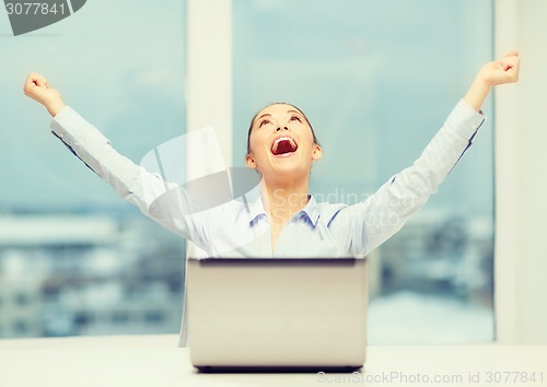 Image of screaming businesswoman with laptop in office
