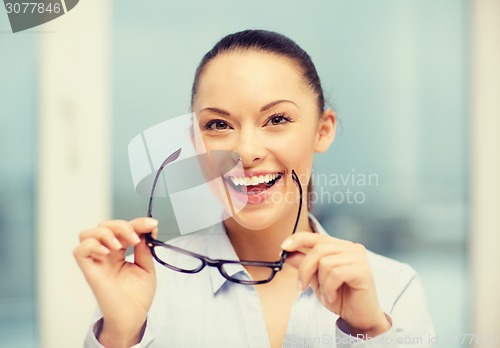 Image of laughing businesswoman with glasses