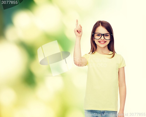 Image of smiling cute little girl in black eyeglasses