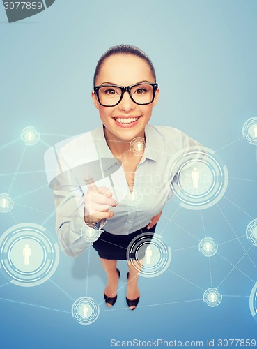 Image of smiling businesswoman with finger up