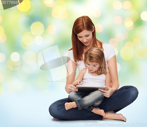 Image of happy mother with little girl and tablet pc