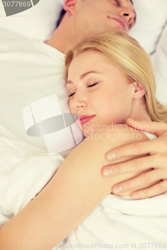 Image of happy couple sleeping in bed