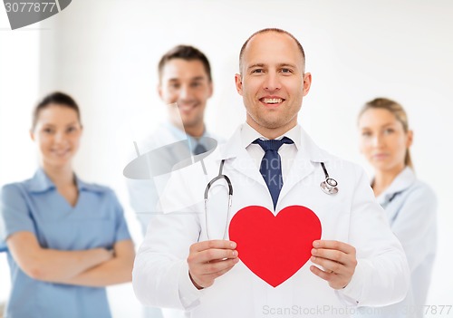 Image of smiling male doctor with red heart and stethoscope