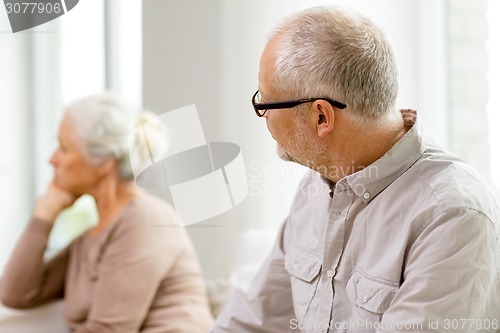 Image of senior couple sitting on sofa at home