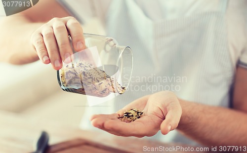 Image of male emptying jar with white and wild black rice
