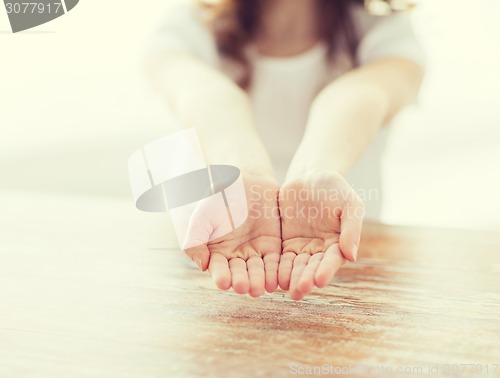 Image of close up of little girl showing empty cupped hands