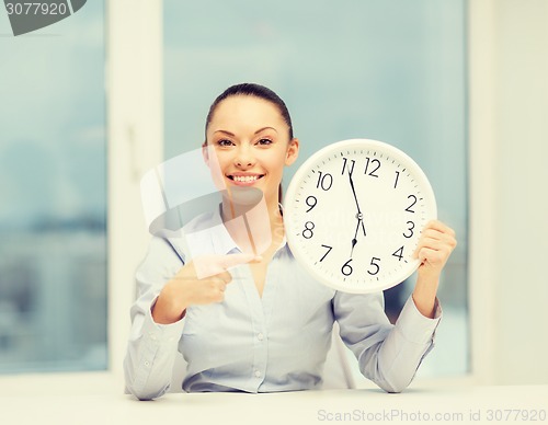 Image of attractive businesswoman with white clock