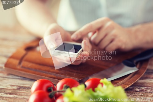 Image of closeup of man pointing finger to smartphone