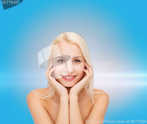 Image of beautiful woman touching her face skin