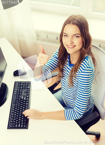 Image of dreaming teenage girl with computer at home