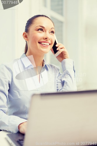 Image of smiling businesswoman with laptop