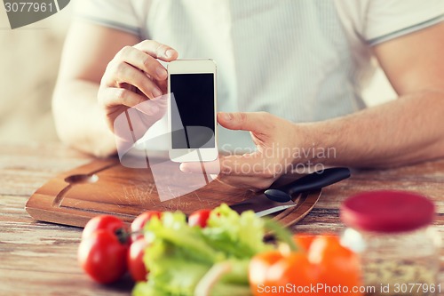 Image of close up of male hands holding smartphone