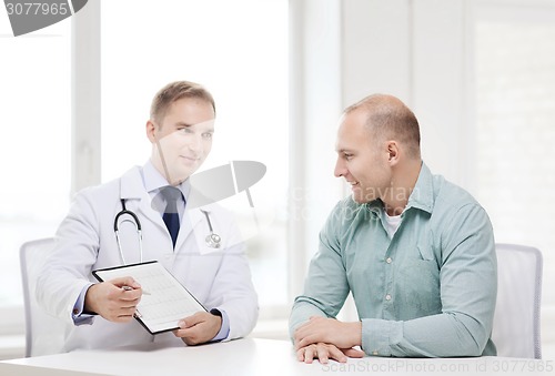 Image of doctor with clipboard and patient in hospital